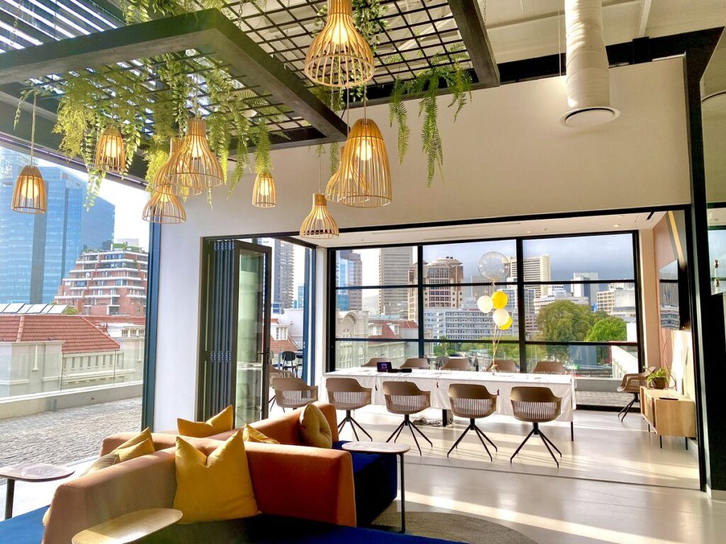 Lamps hanging down from the ceiling of neighborgood workspace in Cape Town