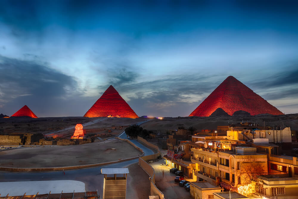 Houses with light and pyramids in sight in a city